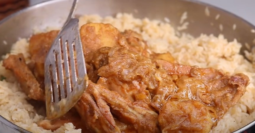 Once the rice and meat are fried together, cover with enough water and salt to taste